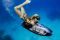 Girl diving underwater with iAQUA AquaDart 720 quest in Barcelona